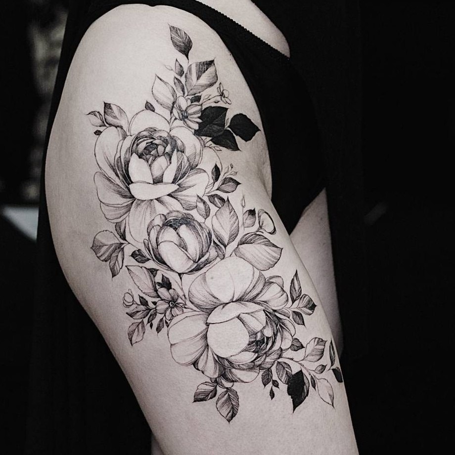 Flowers on thigh tattoo